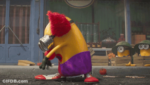 A Clown Is Holding A Chainsaw In Front Of A Salle 'S Store GIF