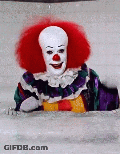 A Clown Is Sitting In A Bathtub With Red Hair And A White Face . GIF