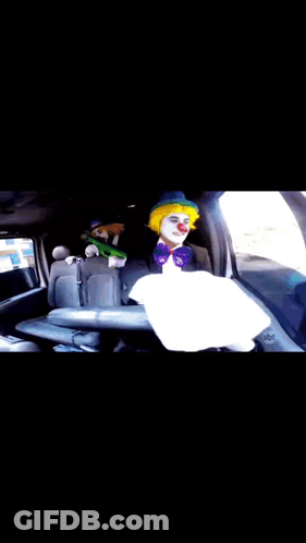 A Clown Is Sitting In The Back Seat Of A Car .. GIF