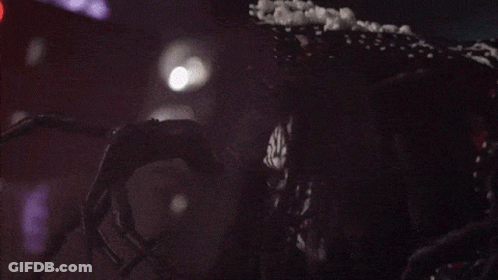 A Clown With A Polka Dot Dress Is Laughing With His Mouth Open GIF