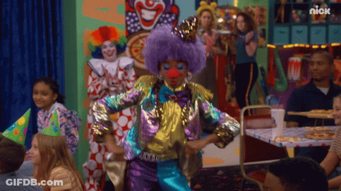 A Clown With A Purple Wig And Red Nose Is Dancing In Front Of A Nick Sign GIF