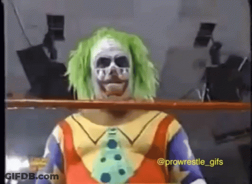 A Clown With Green Hair And A Skull Face Paint GIF