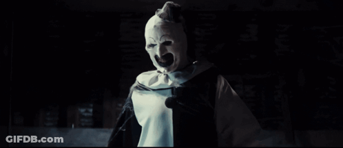 A Clown With His Arms Outstretched Is Wearing A Black And White Costume GIF
