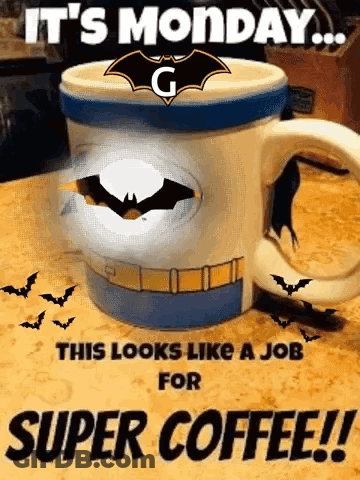 A Coffee Mug With A Batman Logo On It Is On A Table . GIF