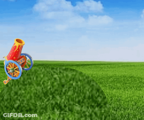 A Colorful Cannon Is Sitting In The Middle Of A Green Field GIF