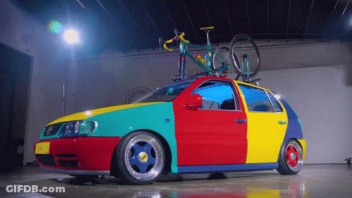 A Colorful Car With A Bike On Top Of It And The Word Costa On The Side GIF