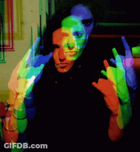 A Colorful Image Of A Person Making A Horns Sign GIF