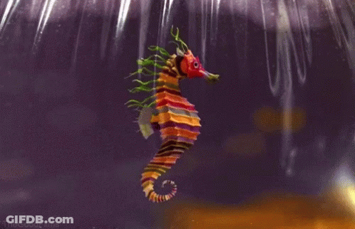 A Colorful Seahorse With A Red Head And Green Tails GIF