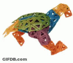 A Colorful Toy That Looks Like A Turtle Is Running On A White Background GIF
