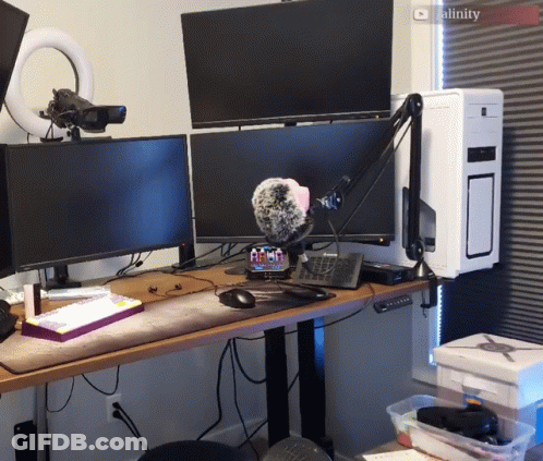 A Computer Desk With Two Monitors And A Microphone And A Screen That Says Cality On It GIF