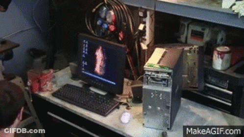 A Computer Is Sitting On A Desk Next To A Broken Computer Tower . GIF