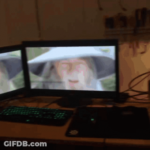 A Computer Monitor Shows A Woman Wearing A White Hat GIF