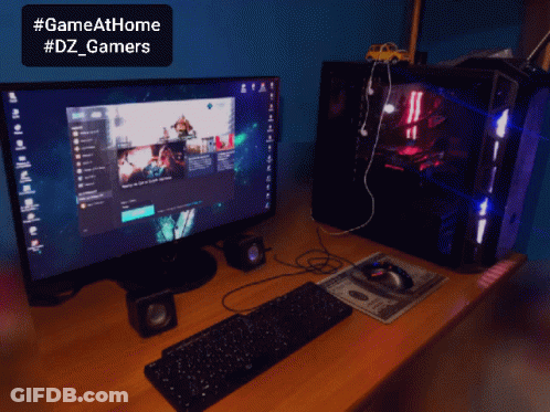A Computer With A Keyboard And Mouse On A Desk With A Sign That Says Gameathome #Dz_gamers GIF