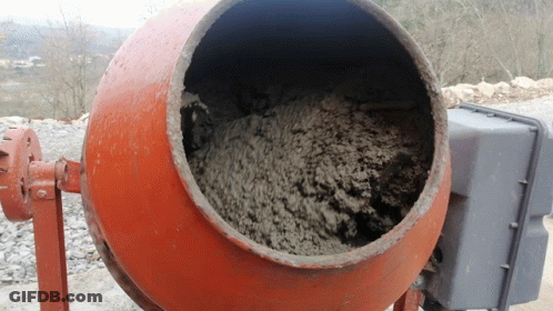 A Concrete Mixer Is Filled With Concrete And Has A Gray Box Behind It GIF