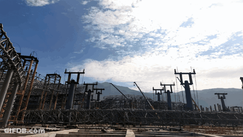 A Construction Site With A Blue Sky Behind It GIF