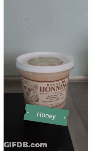A Container Of Dansk Honning Is Sitting On A Table GIF