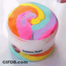 A Container Of Rainbow Bagel Slime With A Swirl In The Middle GIF