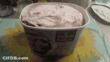 A Container Of Scotsburgh Farmers Ice Cream Is Sitting On A Table GIF