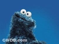 A Cookie Monster From Sesame Street Is Smiling And Looking At The Camera GIF