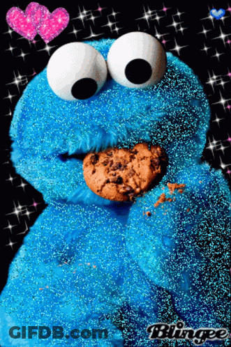 A Cookie Monster Is Eating A Cookie With Hearts In The Background GIF