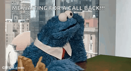 A Cookie Monster Is Sitting At A Desk Waiting For A Call Back .. GIF