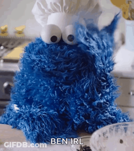 A Cookie Monster Is Sitting On A Counter Wearing A Chef 'S Hat And Saying Ben Irl . GIF
