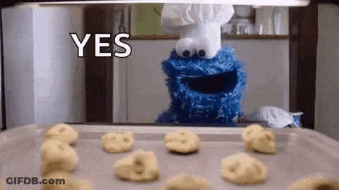 A Cookie Monster Is Standing In Front Of A Pan Of Cookies And Says Yes GIF