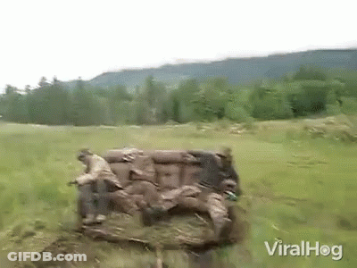 A Couch Is Sitting In The Middle Of A Field . GIF