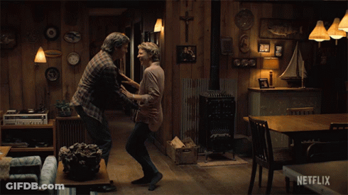 A Couple Dancing In A Living Room With A Netflix Logo On The Bottom GIF