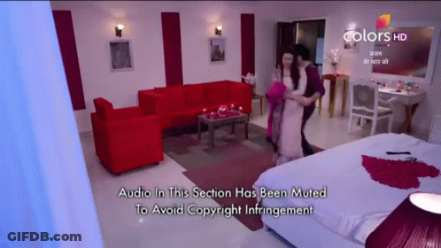 A Couple Dancing In A Living Room With The Words Audio In This Section Has Been Muted To Avoid Copyright Infringement At GIF