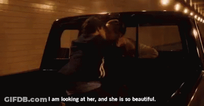 A Couple Is Kissing In The Back Of A Truck . GIF