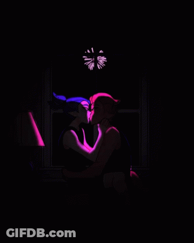 A Couple Kissing In Front Of Fireworks In The Night Sky GIF