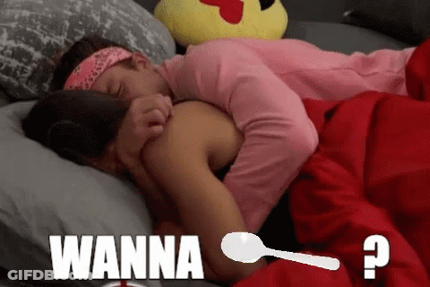 A Couple Laying In Bed With The Word Wanna On The Bottom Right GIF