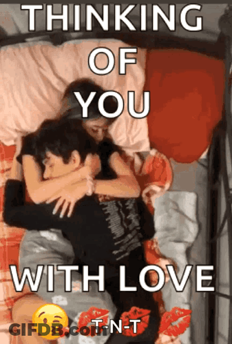 A Couple Laying On A Bed With The Words " Thinking Of You With Love " On The Bottom GIF