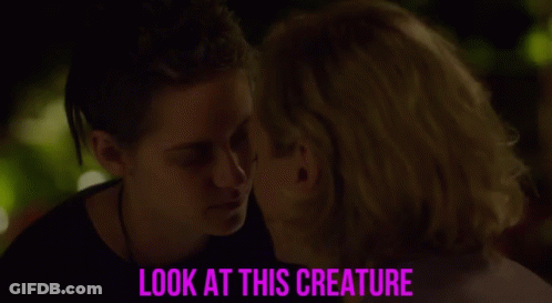 A Couple Looking Into Each Other 'S Eyes With The Caption Look At This Creature GIF