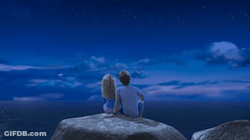 A Couple Looking Up At The Stars In A Blue Sky GIF