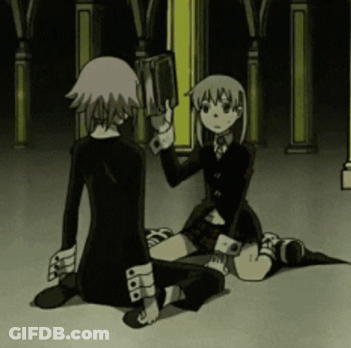 A Couple Of Anime Characters Sitting On The Floor One Of Them Holding A Book GIF