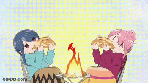 A Couple Of Anime Girls Eating Food In Front Of A Fire GIF