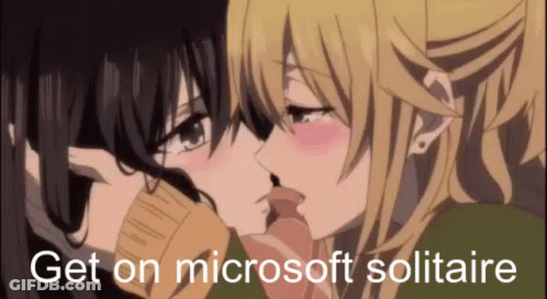 A Couple Of Anime Girls Kissing With The Words `` Get On Microsoft Solitaire '' In The Corner . GIF