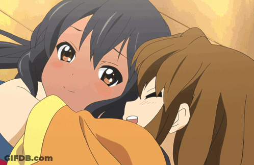 A Couple Of Anime Girls Laying Next To Each Other With One Looking Up At The Camera GIF