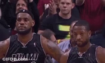 A Couple Of Basketball Players Are Standing Next To Each Other In A Crowd . GIF