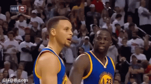 A Couple Of Basketball Players Are Standing Next To Each Other On A Court In Front Of A Crowd . GIF