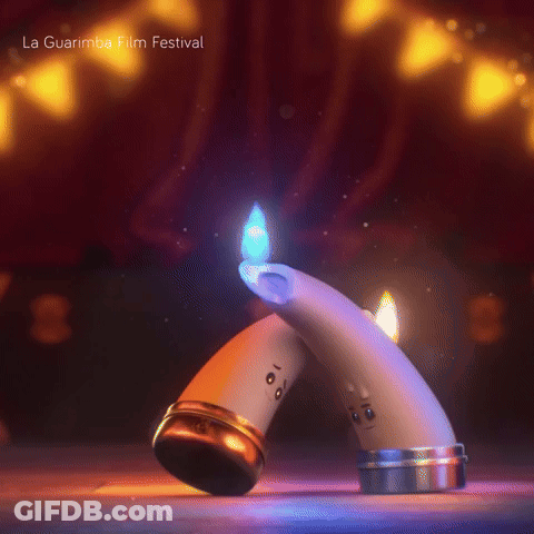 A Couple Of Candles With Faces On Them And The Words La Guarimba Film Festival GIF