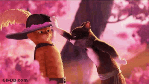 A Couple Of Cartoon Cats Standing Next To Each Other . GIF