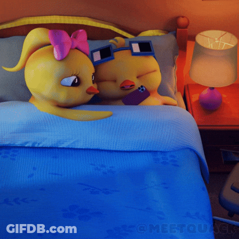 A Couple Of Cartoon Characters Laying On A Bed With A Blue Blanket And A Lamp GIF