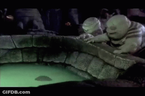 A Couple Of Cartoon Characters Looking At A Glowing Object In The Water GIF