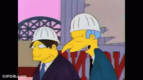 A Couple Of Cartoon Characters Wearing Hard Hats Standing Next To Each Other GIF