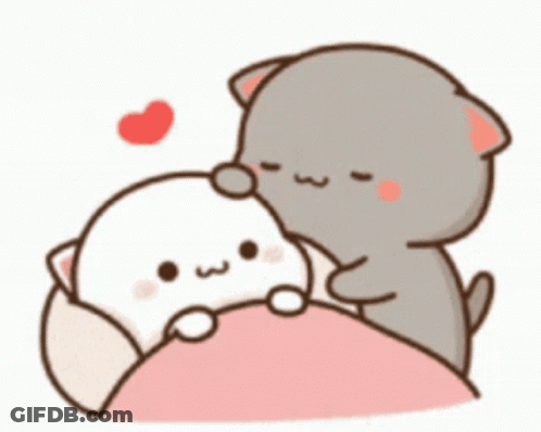 A Couple Of Cats Are Sitting On Top Of A Bed . GIF