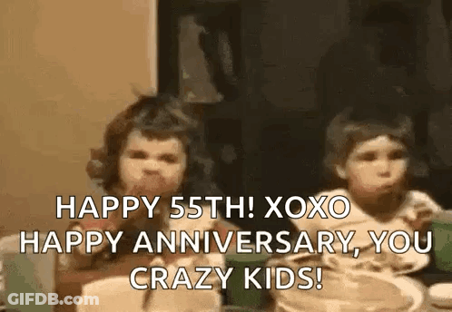 A Couple Of Children Are Sitting At A Table Eating Food And Talking . GIF