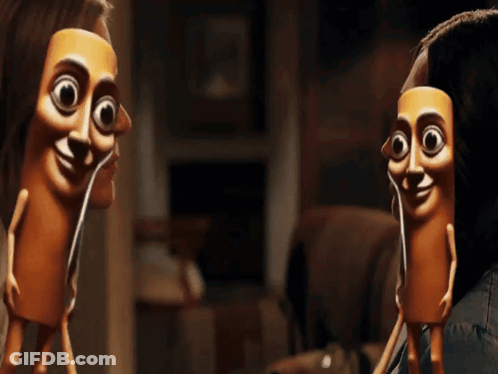 A Couple Of Dolls With Their Faces On Them GIF